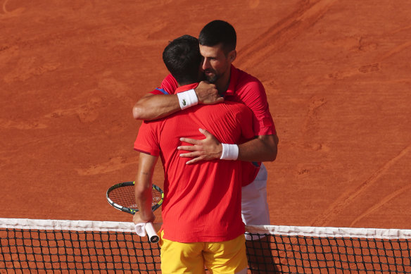 Djokovic embraces Alcaraz after the two-set victory at Roland Garros.