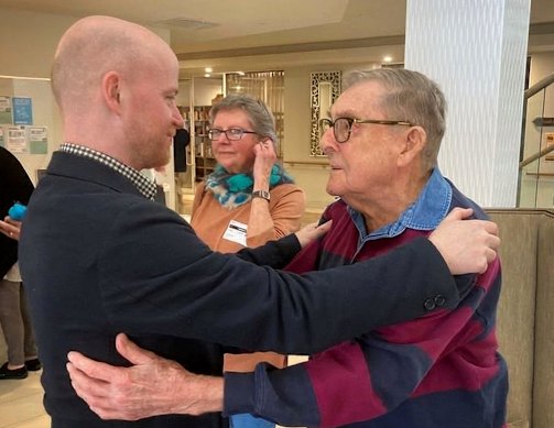 Grandfather figure: Scotts embraces Savage on a 2023 visit to Scotts’ Rosebud aged care home. Scotts’ daughter is in the background.