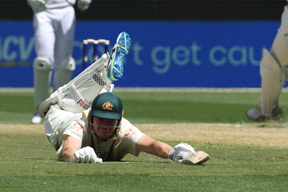 Cameron Green slides on the ground as he unsuccessfully tries to avoid being run out by England.