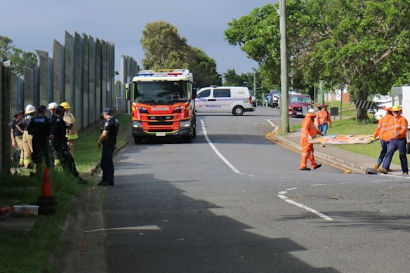 Emergency services work to fix the fence after the car was removed from the tracks.