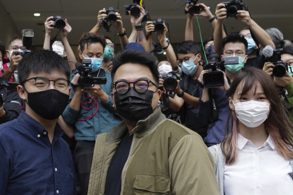 Hong Kong activists, from left, Joshua Wong, Ivan Lam and Agnes Chow arrive at a court in Hong Kong, Monday.