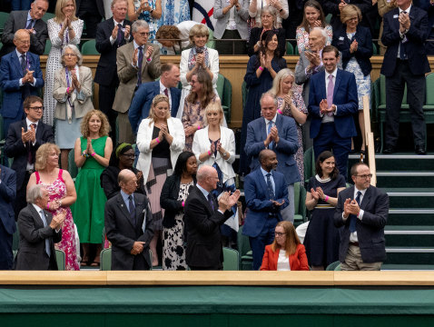 Royals and spectators stand for Sarah Gilbert, seated at bottom right, one of the creators of the AstraZeneca vaccine, in the Royal Box at Wimbledon’s Centre Court. 