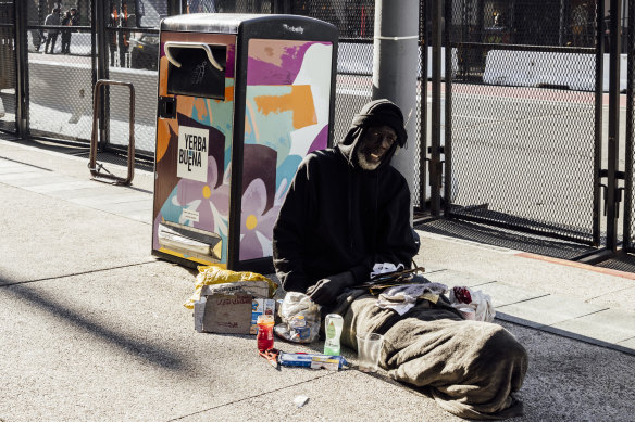 Tony Phillips, who’s been unhoused for eight years, rests near a security fence on Fourth Street, San Francisco, ahead of the start of the 2023 APEC week.