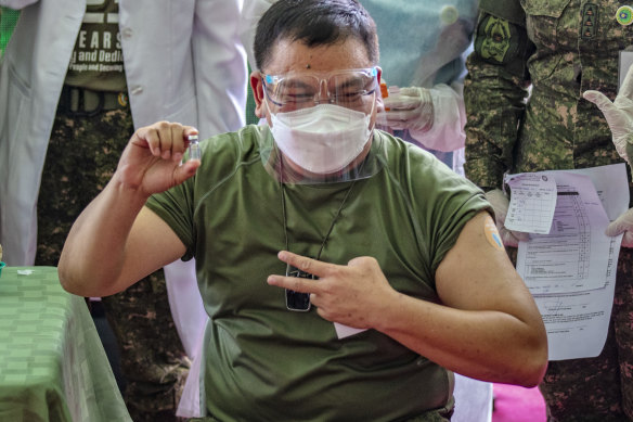 Philippine Army Commanding General Jose Faustino jnr poses with a vial of Sinovac Biotech’s CoronaVac, after being vaccinated last month.