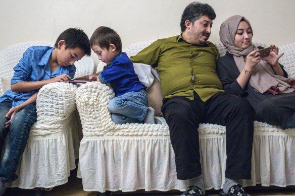 Ablet Abdugani with his daughter Serife, 15, right, and his sons Abdussalam, 11, and Abdullah, five, at home in Istanbul.