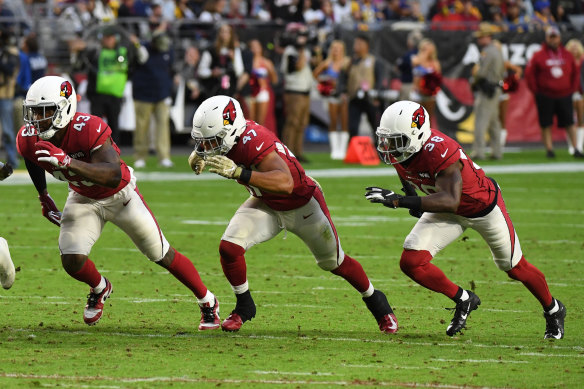 Arizona's Haason Reddick, Ezekiel Turner and Chris Banjo attempt to block a punt against the Rams. 