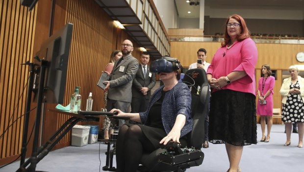 Minister for Defence Linda Reynolds uses a virtual reality flight simulator during a showcase event at Parliament House in Canberra on  December 9 last year. 
