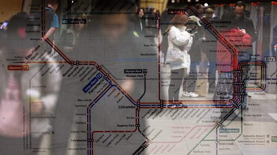 Commuters are seen set against a transport map in an in-camera multiple exposure at the Metro Station at Epping.