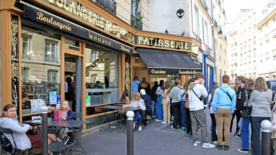 Visitors queue at a patisserie in Paris featured on the Netflix series Emily in Paris.