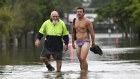 Residents wade through flood waters from ex-tropical cyclone Alfred in Tingalpa on Brisbane’s Eastside on Monday.