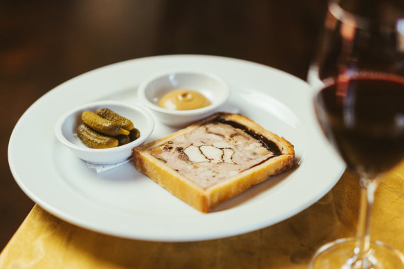 Pâté en croute with mustard and cornichons.