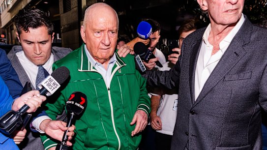 NSW detectives outside Alan Jones’ Circular Quay home on Monday.