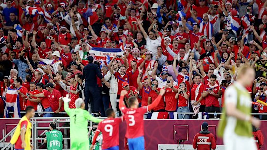 Costa Rican fans celebrate after qualifying for a third successive World Cup.