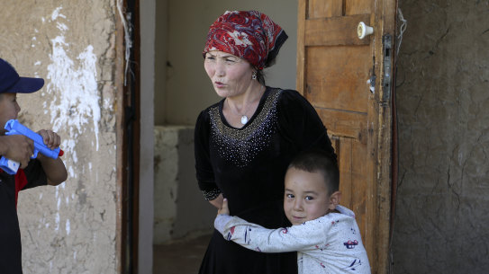 Alif Baqytali hugs his mother, Gulnar Omirzakh, at their new home in Shonzhy, Kazakhstan. Omirzakh, a Chinese-born ethnic Kazakh, says she was forced to get an intrauterine contraceptive device, and that authorities in China threatened to detain her if she didn't pay a large fine for giving birth to Alif, her third child. 