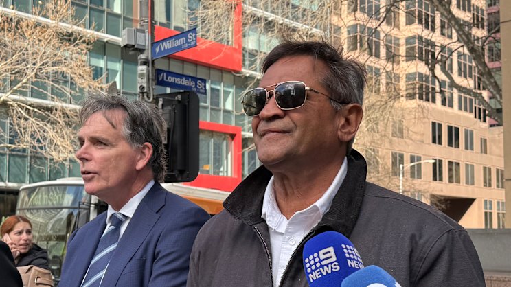 Former AFL player Nicky Winmar outside court