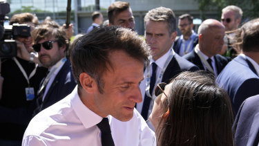 French President Emmanuel Macron kisses a well-wisher at the oceans summit. 
