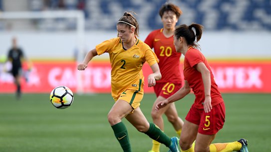 Matildas star Amy Harrison wins the ball from China's Wu Haiyan when they visited Geelong for a friendly in November 2017.