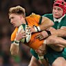 Tate McDermott of Australia is tackled by Craig Casey and Josh van der Flier.