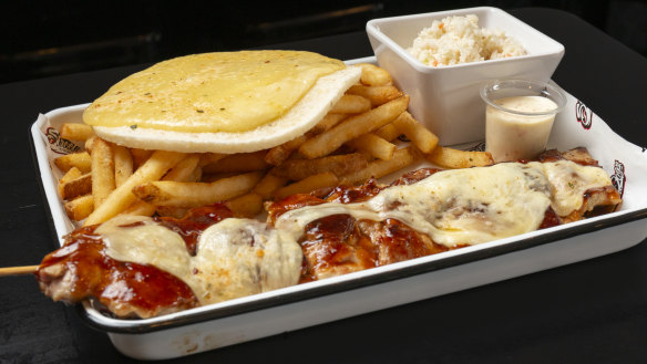 The chicken skewer, with cheese, arepa (corn flatbread), chips and sweet cabbage.