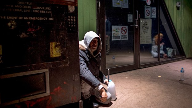 Steve sits next to the needle vending machine outside the safe injecting room.