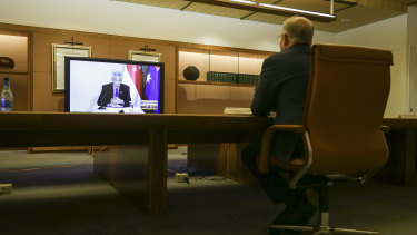 Prime Minister Scott Morrison meets with his Singaporean counterpart Lee Hsien Loong (on the screen) and his delegation during a virtual summit in March. 