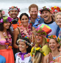 Britain's Prince Harry, the Duke of Sussex and his wife Meghan, the Duchess of Sussex, on Bondi Beach on Friday.
