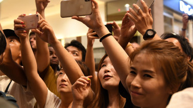 Crowds gathered to cheer for Kim Jong-un as he arrived at the Marina Bay Sands. 