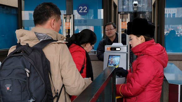 Passengers use the new facial recognition system at Beijing Railway Station.