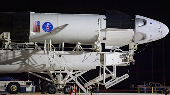 A SpaceX Falcon 9 rocket with the company's Crew Dragon spacecraft is rolled out of the horizontal integration facility at Launch Complex 39A at NASA's Kennedy Space Center in Cape Canaveral, Florida. 