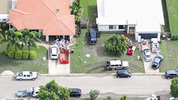 Local residents clean up as floods ease in parts of Townsville on Tuesday.