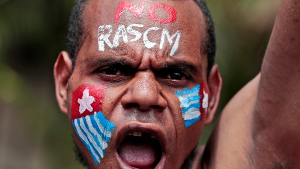A Papuan activist with his face painted with the colours of the separatist Morning Star flag shouts slogans during a rally near the presidential palace in Jakarta last week.