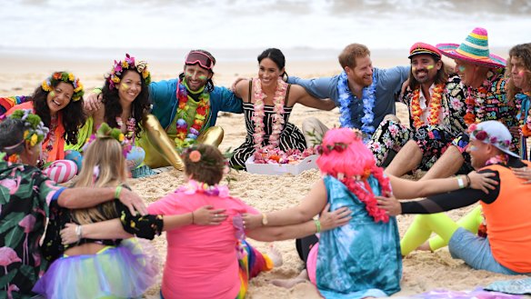 Prince Harry and his wife Meghan take part in a "Fluro Friday" session run by OneWave, a surfing community group raising awareness for mental health and wellbeing, at Bondi Beach.
