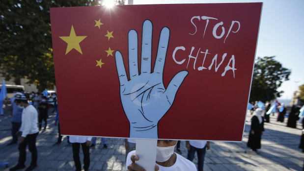 A protester from the Uighur community living in Turkey, holds an anti-China placard during a protest in Istanbul.