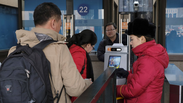 Passengers use the new facial recognition system at Beijing Railway Station.