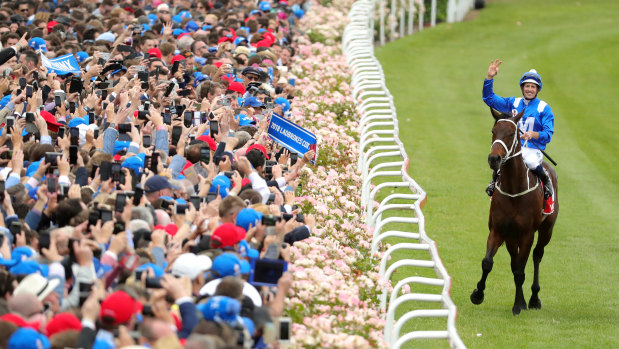 Hugh Bowman enjoys Winx's triumph with the bumper Moonee Valley crowd.