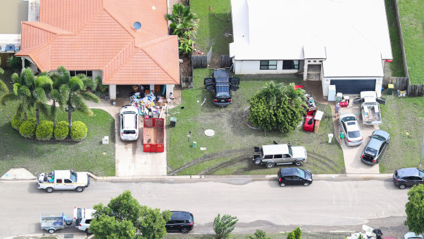 Local residents clean up as floods ease in parts of Townsville on Tuesday.