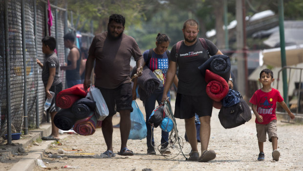 Honduran migrants leave the shelter they were staying at after receiving temporary permission to remain in Mexico.