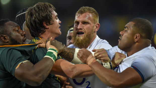 Push and shove: South Africa's Franco Mostert and England's Brad Shields have a minor disagreement.