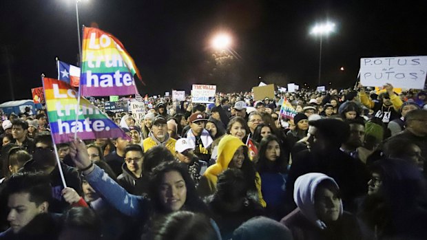 People wait for former congressman Beto O'Rourke to arrive on stage at an outdoor rally across from where US President Donald Trump was holding a rally in El Paso, Texas.