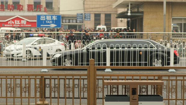 A Mercedes-Benz limousine believed to be part of North Korean leader Kim Jong-un's arrival passes by Beijing railway station.