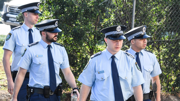 Police arrive at the NSW Coroners Court on Friday.