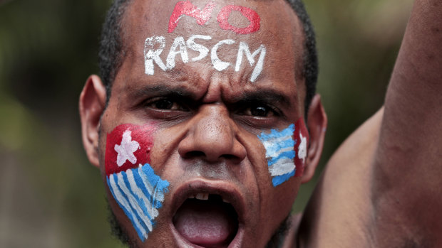 A Papuan activist with his face painted with the colours of the separatist Morning Star flag shouts slogans during a rally near the presidential palace in Jakarta last week.