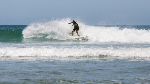 Surfing at Impossibles Beach on the Bukit Peninsula in Bali.