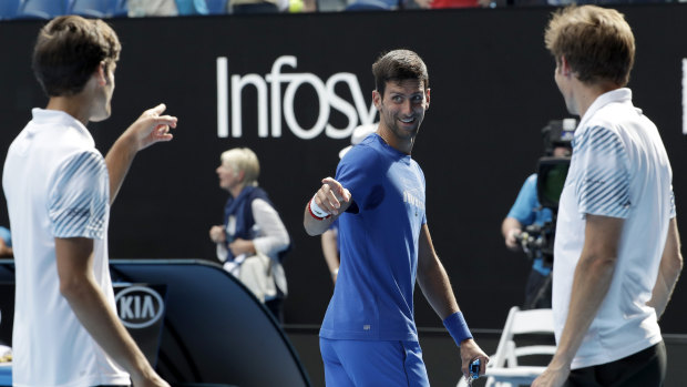 Seal of approval: Serbia's Novak Djokovic, centre, congratulates France's Pierre-Hugues Herbet, left, and his compatriot Nicolas Mahut after their win.
