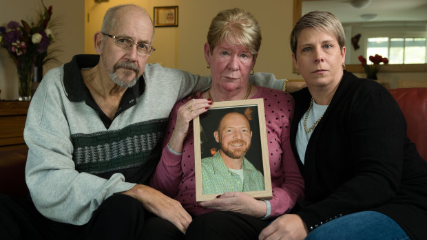 Joy and Mike Van Duinen, with their daughter, Tracey Filocamo, holding a photo of Gary. 