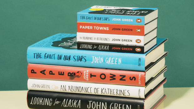Mini book versions of works by John Green compared with their full-size counterparts.