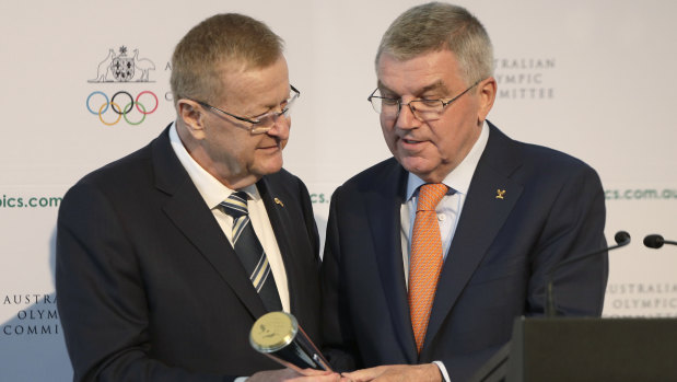 Passing the baton: Bach is presented with the Australian Olympic Committee President's trophy by AOC president John Coates.