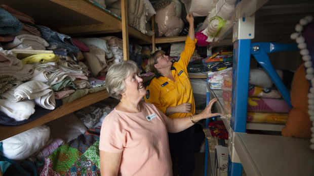 Kerrie O'Grady, president of the Picton branch of the Country Women's Association, and Kim Hill from Buxton Rural Fire Service go over donated supplies at the Community Recovery Centre in Balmoral, which is supporting residents of Buxton, Balmoral and Bargo.
