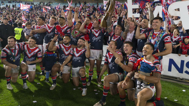 Cock-a-hoop: Sydney Roosters players celebrate in front of their faithful after their grand final victory. 