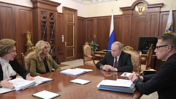 Russian President Vladimir Putin, second right, chairs a meeting on preventing the spread of coronavirus in Moscow, Russia.